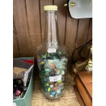 A glass bottle containing marbles.