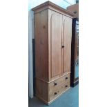 A Victorian pine wardrobe with ebonised handles.
