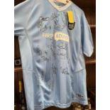 A 2005/2006 Manchester City football shirt, signed by the whole team, new shirt with tags.