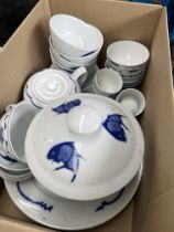 A box of Chinese blue and white ceramics decorated with fish.