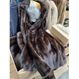 A brown mink full length fur coat with matching hat.