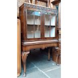 An early 20th century walnut cabinet on stand.