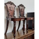 A pair of 19th century mahogany hall chairs in the manner of Gillows, having reeded legs and