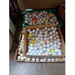 Three boxes of used golf balls