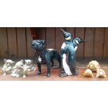 A group of Beswick animal figures including a black Staffordshire bull terrier, pair of penguins (