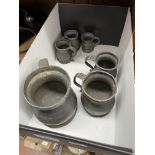 A graduated set of pewter tankards.