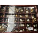 A display case containing various miniature clocks.