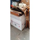 A box of assorted pictures & prints and a bundle of walking sticks