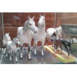 A group of Beswick horse figures, dappled grey with chestnut foal on ceramic plinth (marked to