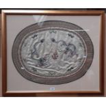 A Chinese embroidered silk textile depicting dragons, framed and glazed, 88cm x 73.5cm.