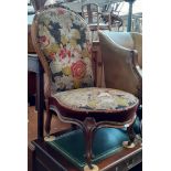 A Victorian walnut spoon back bedroom chair with cabriole legs and needlework upholstery.