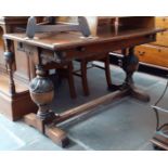 An early 20th century extending oak refectory table on carved baluster supports, height 76cm, length