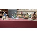4 hand painted vintage metal figures depicting middle eastern or African tribesmen selling goods