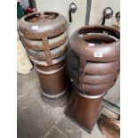 Two large salt glazed chimney pots.