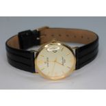 A 9ct Sovereign wristwatch, case diam. 32mm, leather strap.