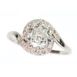 A 1940s diamond cluster ring, the principal eight claw set round cut diamond weighing approx. 0.