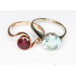Two rings; a hallmarked 9ct gold garnet ring and a white metal ring set with a blue zircon marked '