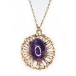 A modern hallmarked 9ct gold amethyst cabochon pendant, length 30mm, on 40cm chain marked '9ct',