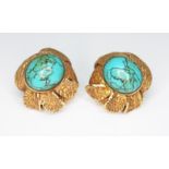 A pair of turquoise earrings, each of flower form set with a turquoise cabochon and surrounded by