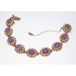 An amethyst and cultured pearl bracelet, nine clusters featuring a central oval mixed cut amethyst