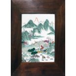 A Chinese porcelain panel, circa 1900, over enamel decoration depicting a mountainous landscape with