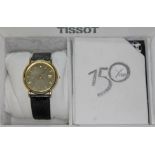 A Tissot 18ct gold wristwatch, diam. 35mm, with box and papers.