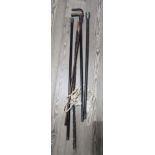 A bundle of antique walking sticks to include with silver and white metal.