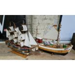 Two wooden model boats; H.M.S. Endeavor and one other.