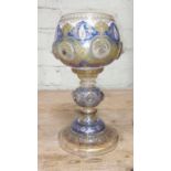 A late 19th century near eastern style cut and enamelled glass goblet, height 24cm.