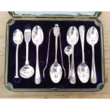 Assorted hallmarked silver spoons and sugar tongs.