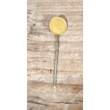 A 19th century US one dollar gold coin soldered on a stick pin
