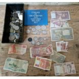 A tin of assorted GB & world coins and banknotes to include some silver etc.