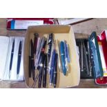 A box of assorted pens and pencils