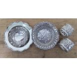 Four pieces of hallmarked silver comprising three small dishes and a pair of serviette rings,