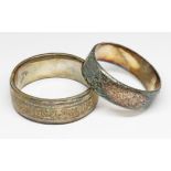 A hallmarked silver bangle and another unmarked.
