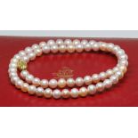 A single strand of cultured pearls, clasp marked '585'.