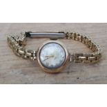 A ladies 9ct gold watch with gold plated strap.