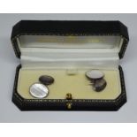 Two pairs of Pakeman Catto & Carter cufflinks, one silver set with mother of pearl and the other