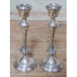 A pair of hallmarked silver filled candlesticks, height 20cm.