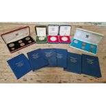 A group of coin sets to include 2 Royal Mint silver proof silver jubilee crowns, an Isle of Man