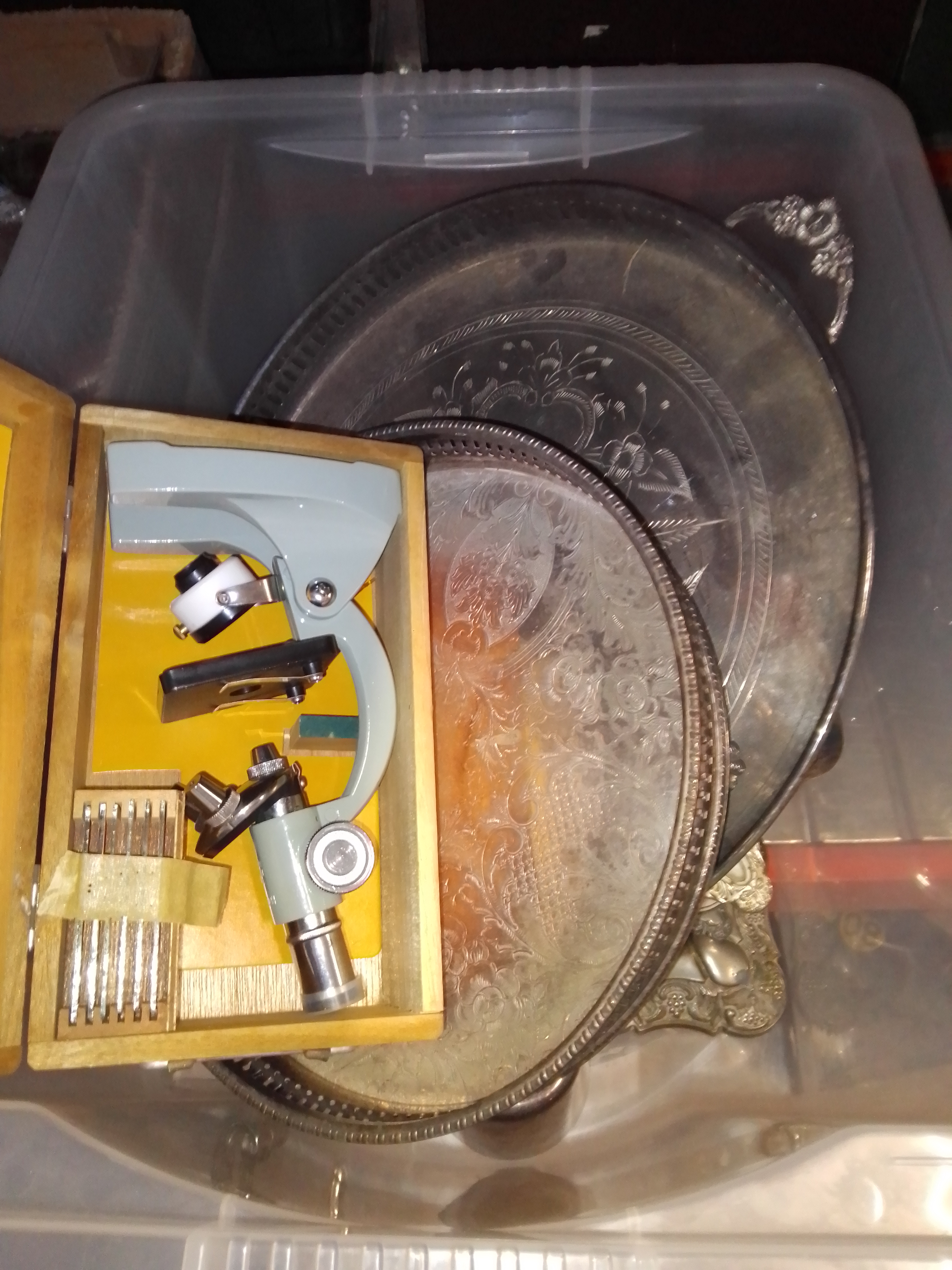 A box of assorted silver plated ware and a boxed microscope.