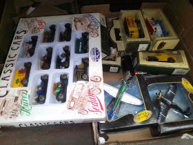 A box of boxed toy cars, vans and aeroplanes