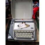 Two portable typewriters, an Adler Tipper and a Smith Corona