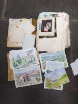 A collection of postcard designs and a scrapbook of vintage postcards.