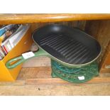 A Le Creuset griddle pan and three metal trivets