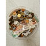 A tub of world coins & banknotes