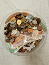 A tub of world coins & banknotes