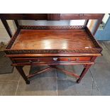 A hardwood side table with cross stretcher and pierced gallery.