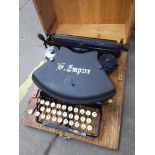 A vintage Empire typewriter in a wooden case