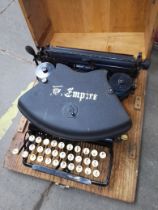A vintage Empire typewriter in a wooden case